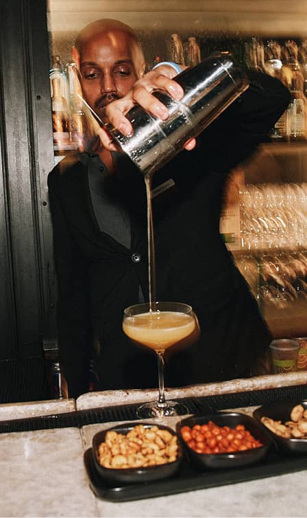 bartender pouring cocktail drink